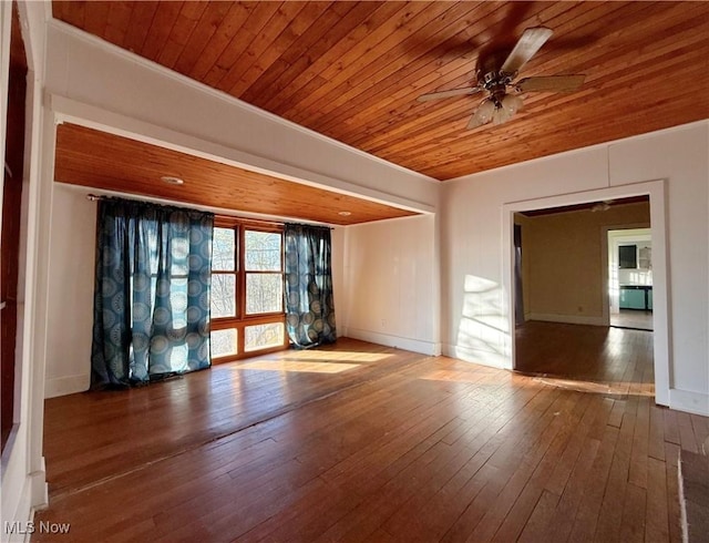 spare room featuring hardwood / wood-style flooring, ceiling fan, crown molding, and wood ceiling