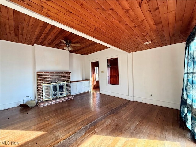 unfurnished living room featuring hardwood / wood-style flooring, a brick fireplace, and wooden ceiling