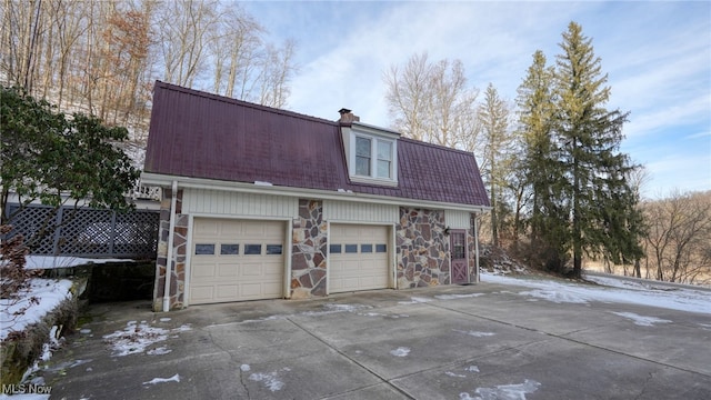 view of snowy exterior with a garage