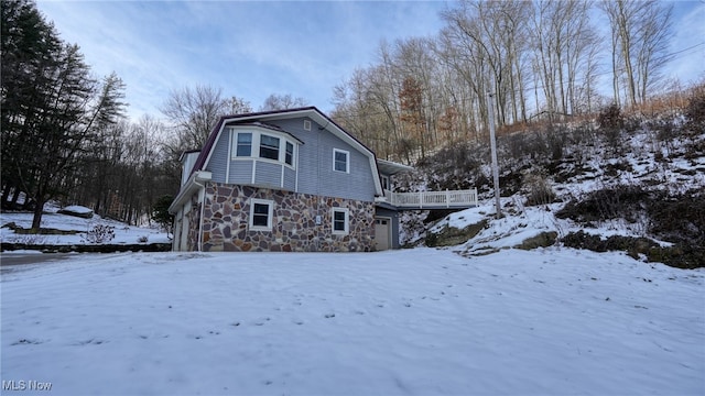 snow covered property featuring a garage