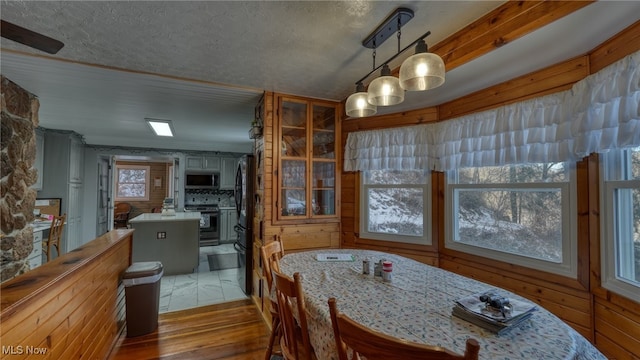 2250 Indian Camp Run Rd, New Concord, OH 43762 - dining room featuring light wood-type flooring and a textured ceiling