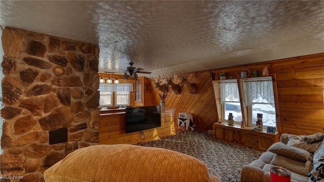 2250 Indian Camp Run Rd, New Concord, OH 43762 - carpeted living area featuring a textured ceiling, wooden walls, and ceiling fan