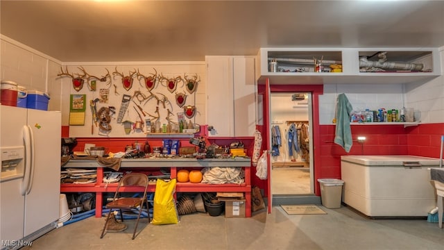 misc room featuring concrete flooring and a workshop area