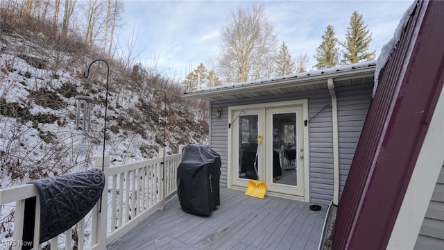 snow covered deck with area for grilling