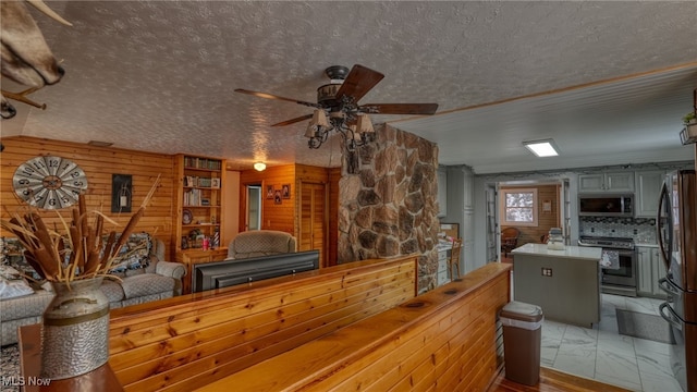 interior space featuring ceiling fan and a textured ceiling