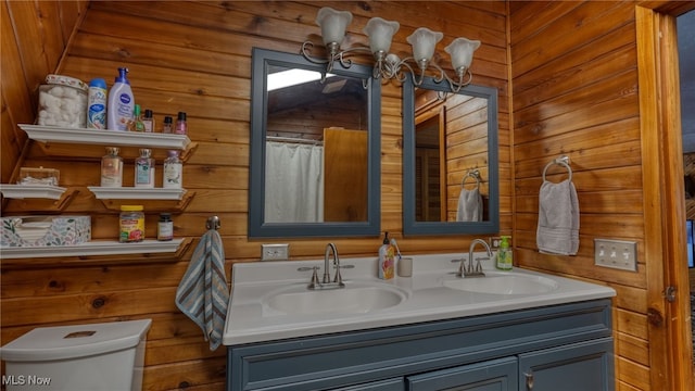 2250 Indian Camp Run Rd, New Concord, OH 43762 - full bathroom featuring a sink, toilet, double vanity, and wooden walls