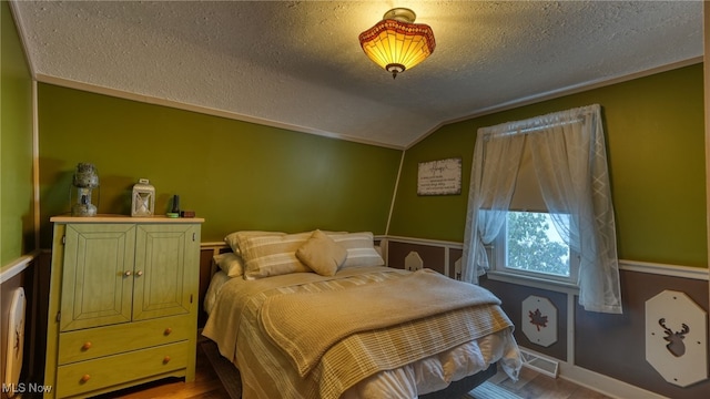 2250 Indian Camp Run Rd, New Concord, OH 43762 - bedroom with a textured ceiling, visible vents, vaulted ceiling, wood finished floors, and baseboards