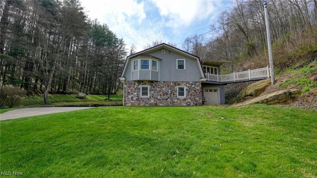 2250 Indian Camp Run Rd, New Concord, OH 43762 - exterior space featuring a front lawn, stone siding, and a garage