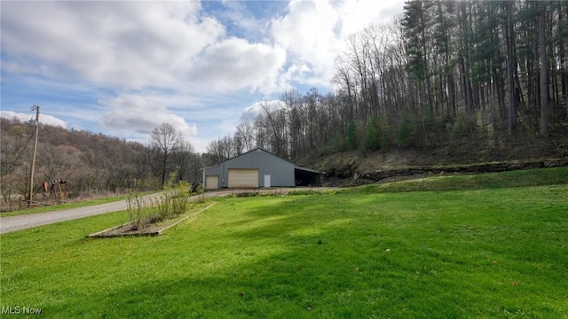 2250 Indian Camp Run Rd, New Concord, OH 43762 - view of yard featuring driveway, an outdoor structure, a garage, and a pole building