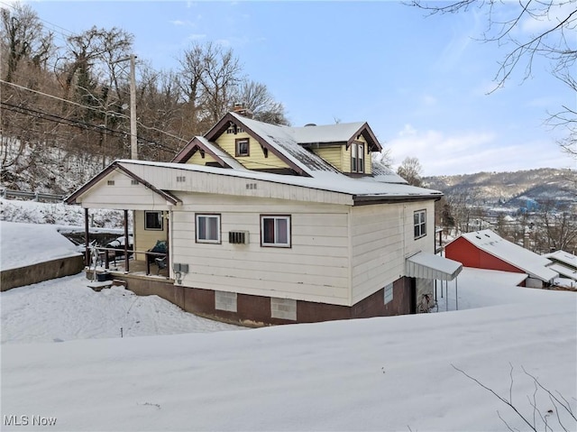 snow covered house with covered porch