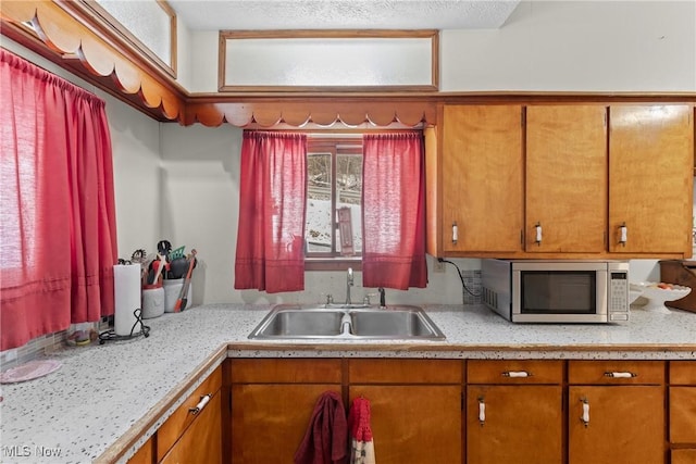 kitchen featuring sink and a textured ceiling