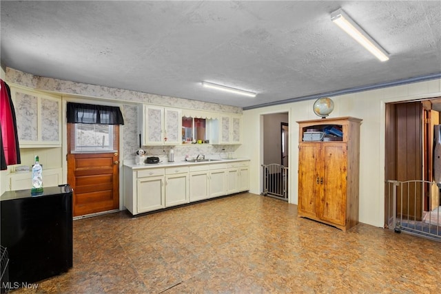 kitchen featuring sink and a textured ceiling