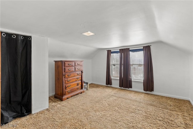 bonus room with lofted ceiling and carpet floors