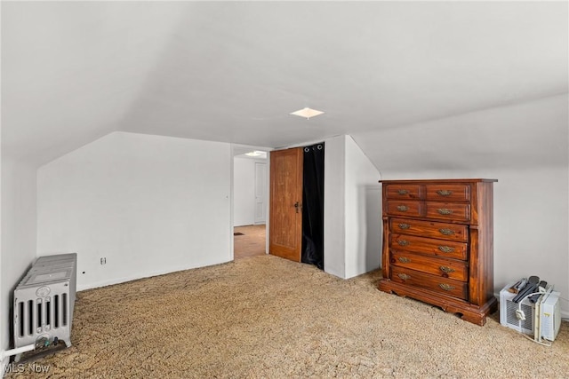 bonus room featuring light colored carpet and vaulted ceiling