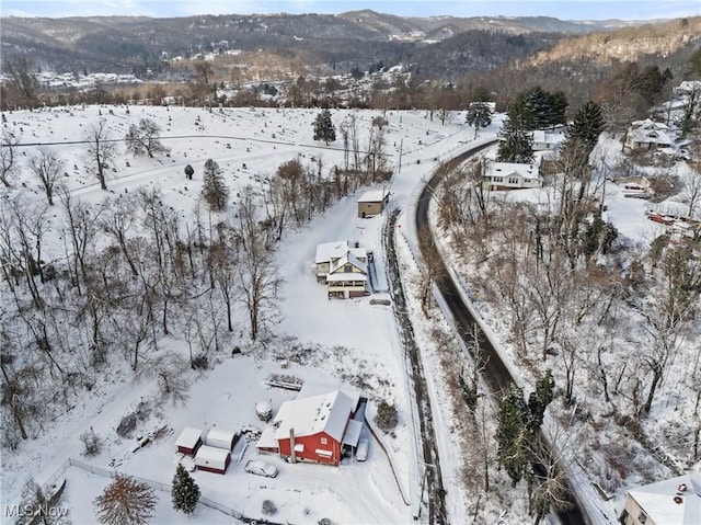 snowy aerial view featuring a mountain view