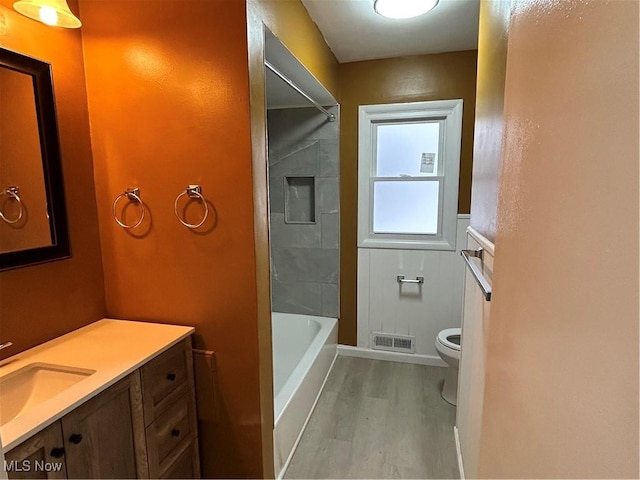 bathroom featuring vanity, wood-type flooring, and toilet