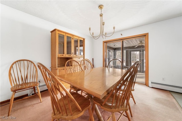 carpeted dining space featuring a baseboard radiator and an inviting chandelier