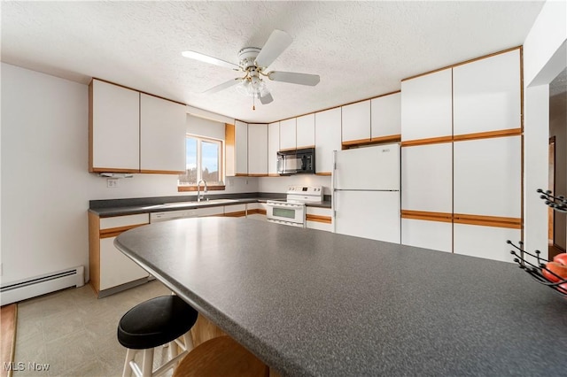 kitchen with a baseboard heating unit, a textured ceiling, white cabinets, and white appliances