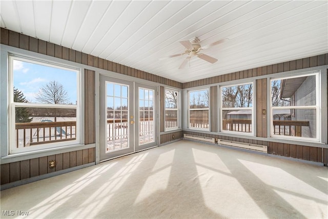 unfurnished sunroom featuring ceiling fan and a baseboard heating unit