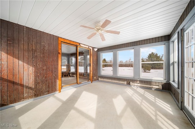 unfurnished sunroom featuring ceiling fan and a baseboard radiator