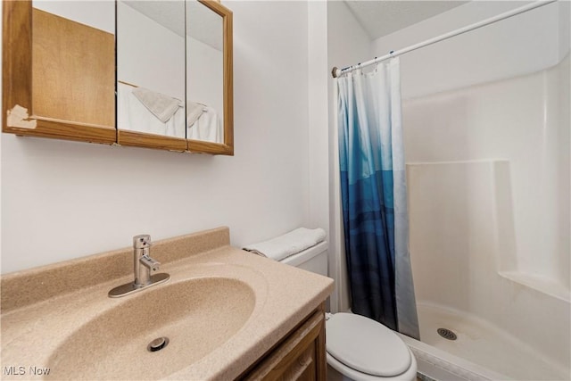 bathroom featuring vanity, toilet, and a shower with shower curtain