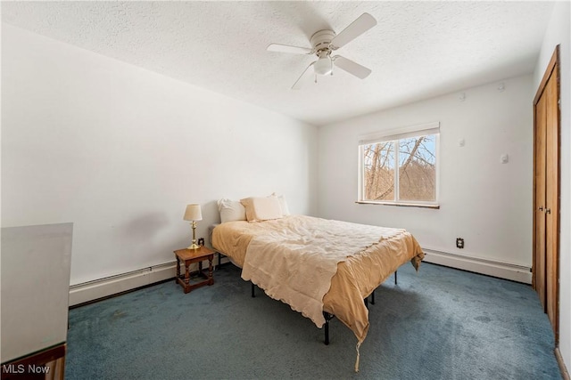 bedroom featuring carpet flooring, a textured ceiling, and baseboard heating