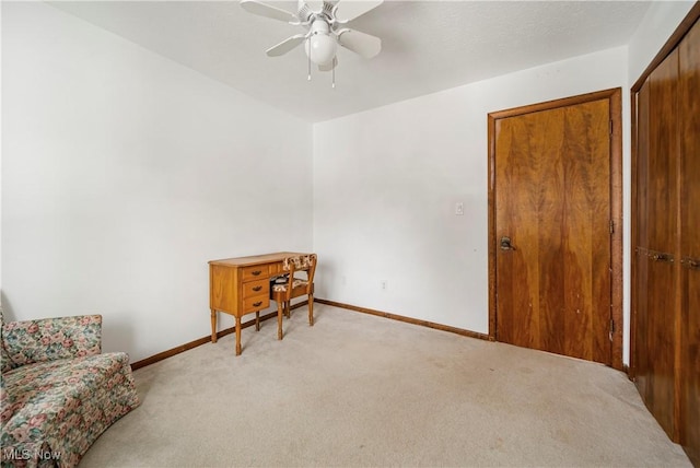 living area featuring ceiling fan and light colored carpet