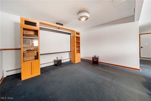 cinema with dark colored carpet and a baseboard heating unit