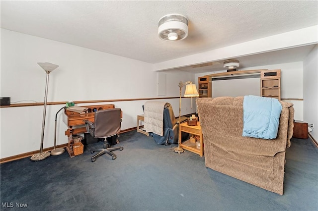 carpeted office space featuring a textured ceiling