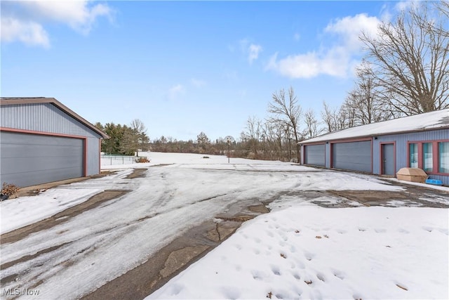 yard covered in snow with a garage