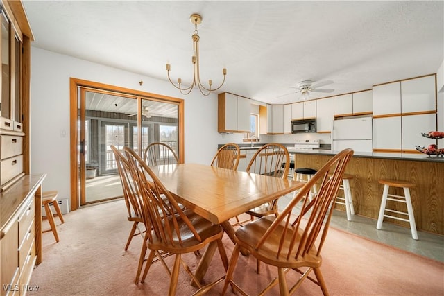 carpeted dining area featuring ceiling fan, sink, and a baseboard heating unit