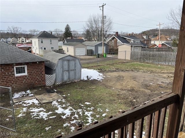 yard covered in snow featuring a shed