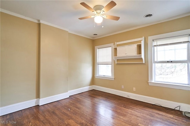 spare room with crown molding, dark wood-type flooring, and ceiling fan