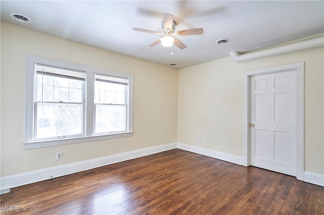 empty room featuring ceiling fan and dark hardwood / wood-style floors