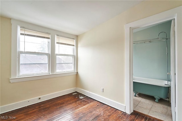 unfurnished bedroom featuring dark wood-type flooring and a closet