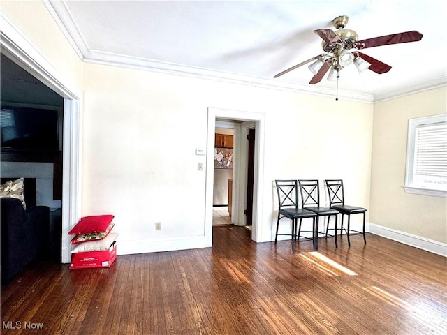 empty room with dark wood-type flooring, ornamental molding, and ceiling fan