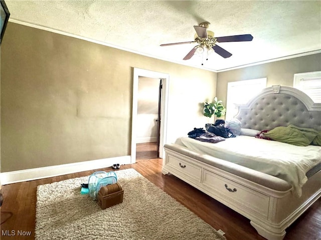 bedroom with crown molding, a textured ceiling, and dark hardwood / wood-style flooring