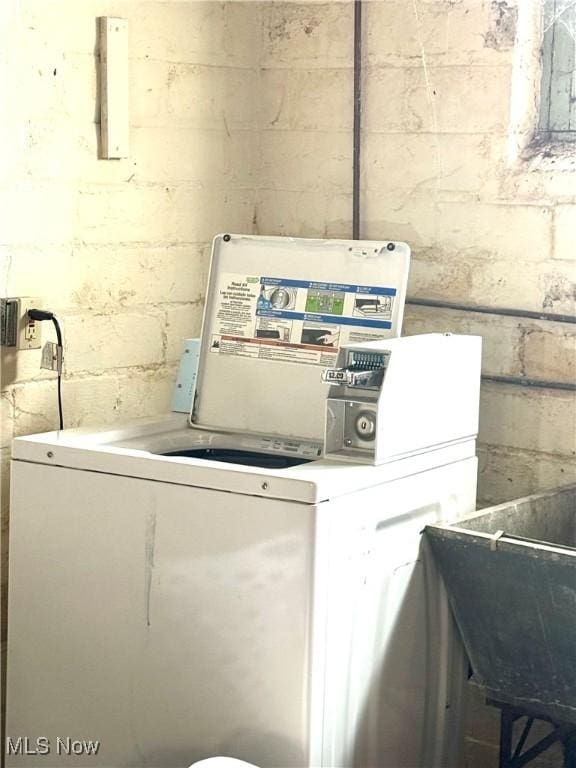 laundry area featuring washer / clothes dryer and sink