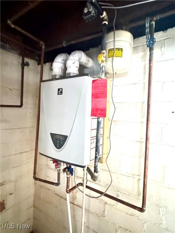 utility room with tankless water heater