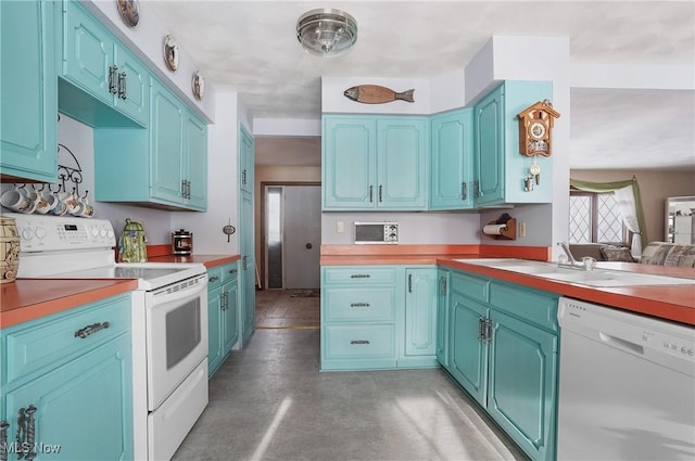 kitchen with concrete flooring, butcher block countertops, sink, blue cabinetry, and white appliances