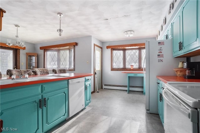 kitchen featuring pendant lighting, sink, white appliances, blue cabinetry, and a baseboard heating unit