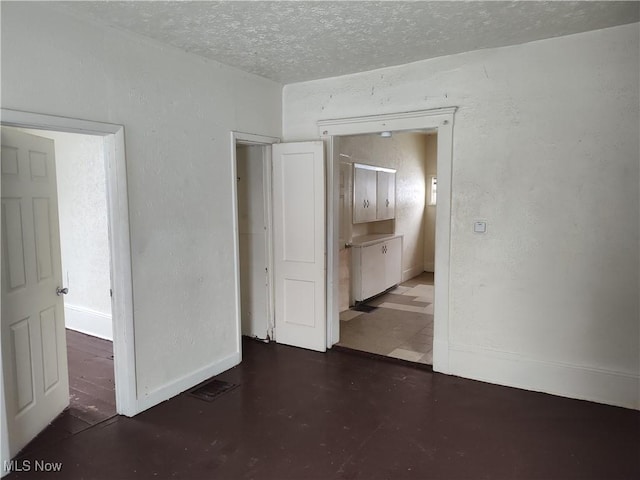 empty room featuring a textured ceiling