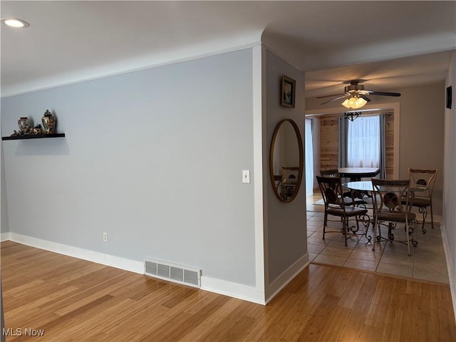 dining space with wood-type flooring and ceiling fan