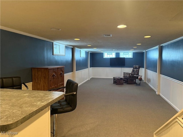 interior space featuring crown molding and carpet