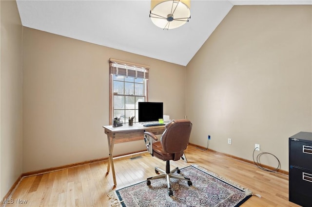 office featuring high vaulted ceiling and light hardwood / wood-style flooring