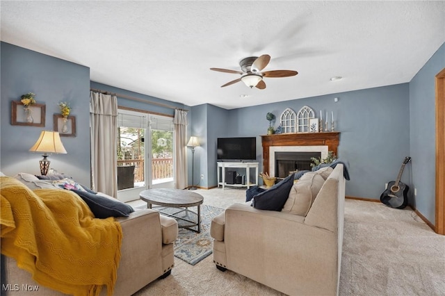 carpeted living room with a textured ceiling and ceiling fan