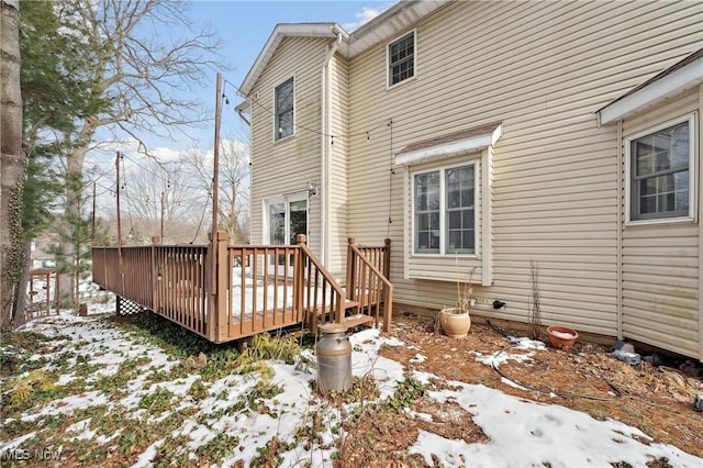 snow covered property featuring a wooden deck