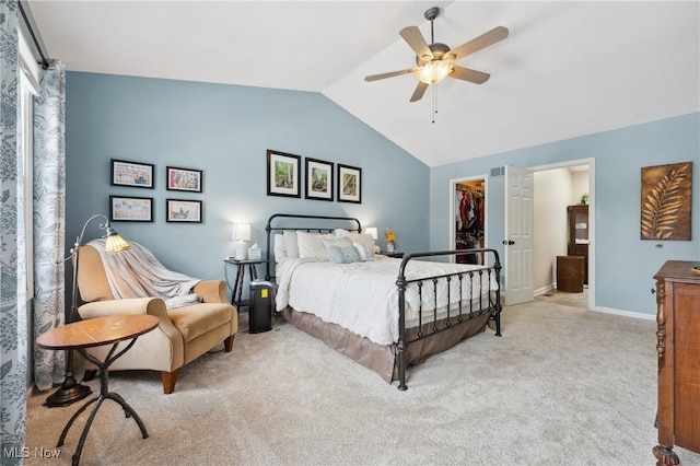 bedroom featuring lofted ceiling, a spacious closet, light carpet, and ceiling fan