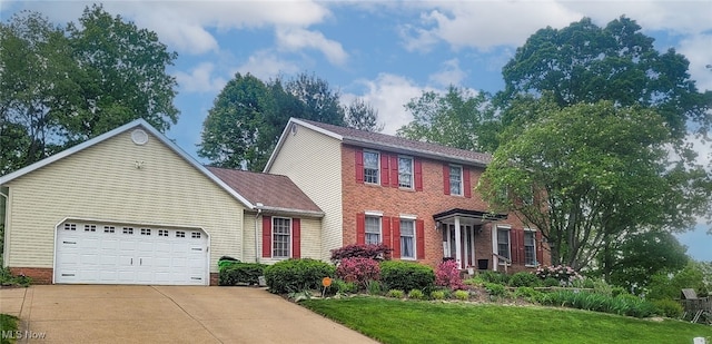 colonial-style house with a garage and a front lawn