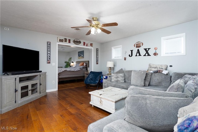 living room with ceiling fan, a healthy amount of sunlight, and dark hardwood / wood-style flooring